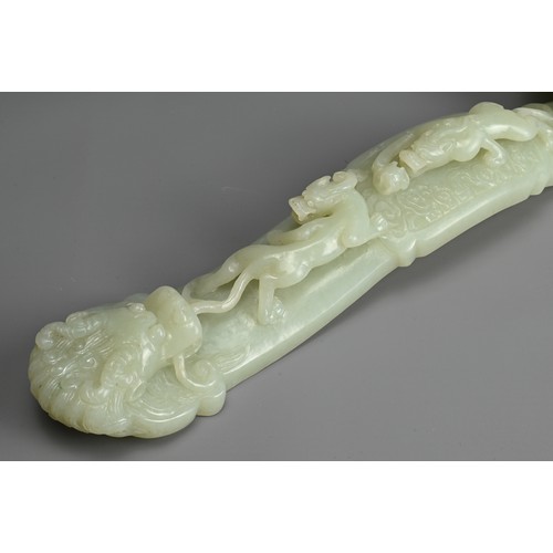 40 - A CHINESE JADE RUYI SCEPTRE WITH MIRROR AND CORAL FIGURE. The ruyi sceptre carved in relief with boy... 