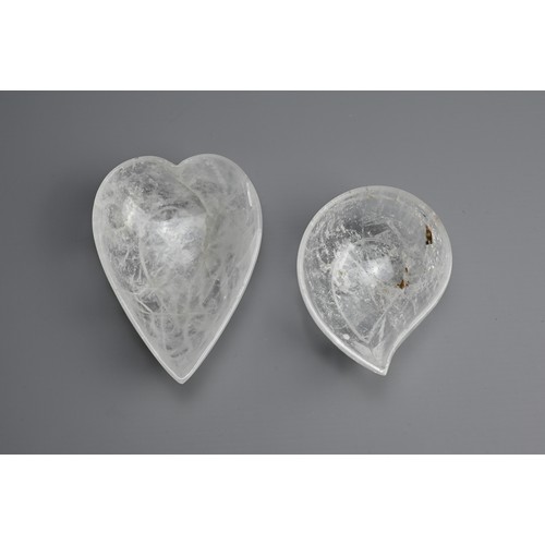 42 - TWO POLISHED ROCK CRYSTAL BOWLS. Clear heart and mango shaped bowls each on a raised foot. 10.5cm an... 