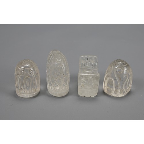 45 - FOUR FATIMID STYLE CARVED ROCK CRYSTAL CHESS PIECES. With incised decoration. 2.5cm to 3.5cm tall. (... 