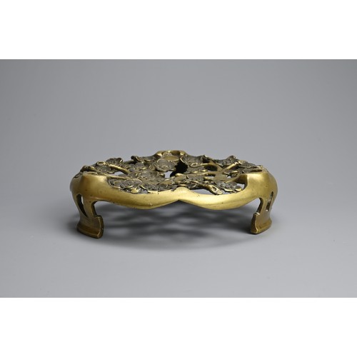 49 - A CHINESE / JAPANESE BRONZE TRIPOD STAND, 19TH CENTURY. Pierced circular stand with prunus flowers. ... 