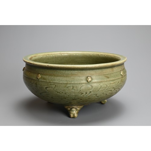 166 - A CHINESE LONGQUAN CELADON TRIPOD CENSER, MING DYNASTY (1368-1644). Thickly potted with carved flora... 