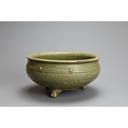 166 - A CHINESE LONGQUAN CELADON TRIPOD CENSER, MING DYNASTY (1368-1644). Thickly potted with carved flora... 