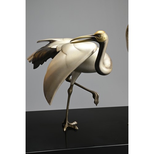 305 - A PAIR OF JAPANESE SILVERED BRONZE CRANES, TOSHIKAZU, 20TH CENTURY. Mounted on a wooden base by Tosh... 