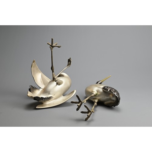 305 - A PAIR OF JAPANESE SILVERED BRONZE CRANES, TOSHIKAZU, 20TH CENTURY. Mounted on a wooden base by Tosh... 