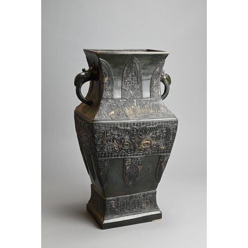 295 - A LARGE CHINESE ARCHAISTIC BRONZE VASE, FANGHU. Of square baluster form decorated with archaic motif... 