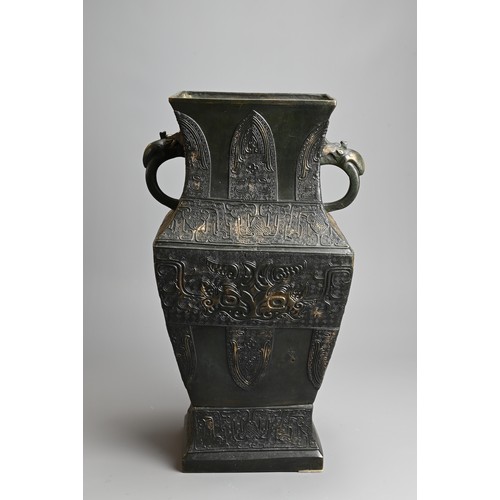 295 - A LARGE CHINESE ARCHAISTIC BRONZE VASE, FANGHU. Of square baluster form decorated with archaic motif... 