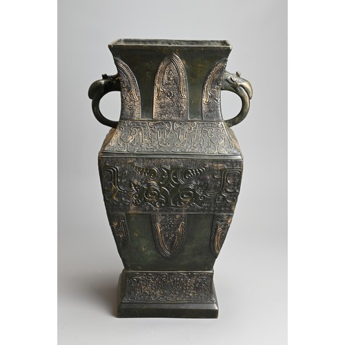 295 - A LARGE CHINESE ARCHAISTIC BRONZE VASE, FANGHU. Of square baluster form decorated with archaic motif... 