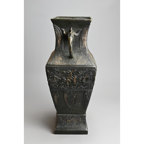 295 - A LARGE CHINESE ARCHAISTIC BRONZE VASE, FANGHU. Of square baluster form decorated with archaic motif... 