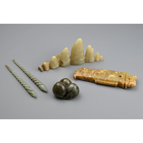 125 - A CHINESE CARVED PALE JADE BOULDER-SHAPED BRUSH REST AND OTHER ITEMS OF JADE. The first, formed as a... 