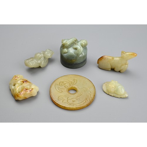 130 - SIX CHINESE JADE CARVINGS. Comprising: a pale jade carving of a standing figure, another of a recumb... 