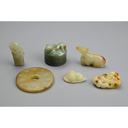 130 - SIX CHINESE JADE CARVINGS. Comprising: a pale jade carving of a standing figure, another of a recumb... 