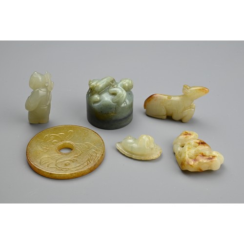 130 - SIX CHINESE JADE CARVINGS. Comprising: a pale jade carving of a standing figure, another of a recumb... 