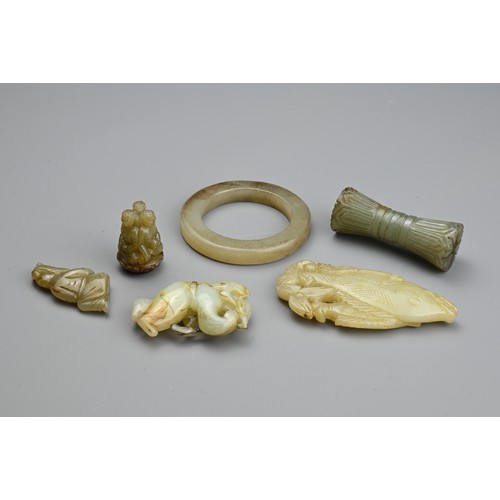 132 - SIX CHINESE JADE CARVINGS. Comprising: a mottled pendant carved with three buddhas atop a lotus, a s... 