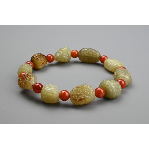 134 - TWO CHINESE CARVED JADE PENDANTS AND A BRACELET. A pale jade pendant of shaped rectangular form, car... 