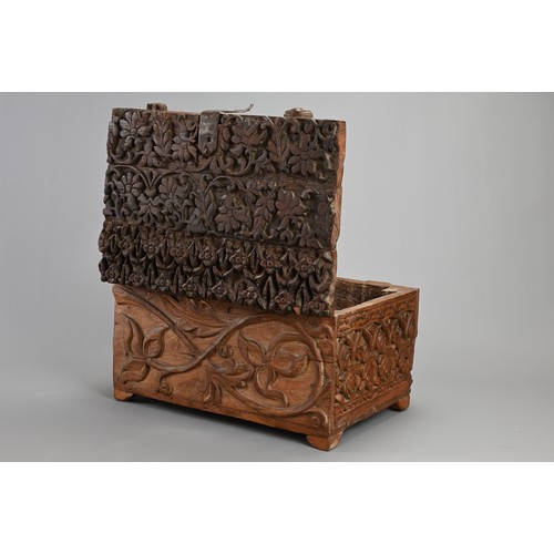 121 - AN ANGLO INDIAN CARVED WOODEN CHEST, 20TH CENTURY. Of rectangular form with iron hinge, deeply carve... 