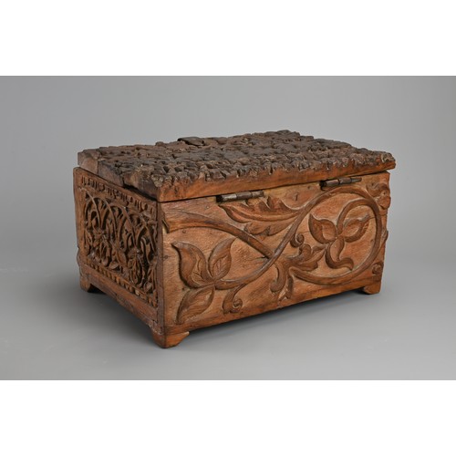 121 - AN ANGLO INDIAN CARVED WOODEN CHEST, 20TH CENTURY. Of rectangular form with iron hinge, deeply carve... 