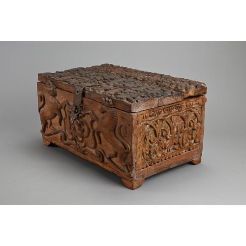 121 - AN ANGLO INDIAN CARVED WOODEN CHEST, 20TH CENTURY. Of rectangular form with iron hinge, deeply carve... 