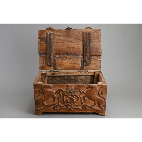 121 - AN ANGLO INDIAN CARVED WOODEN CHEST, 20TH CENTURY. Of rectangular form with iron hinge, deeply carve... 