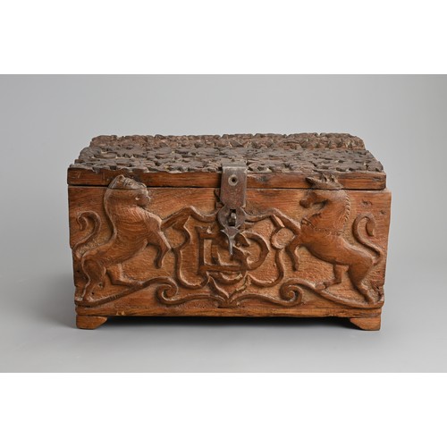 121 - AN ANGLO INDIAN CARVED WOODEN CHEST, 20TH CENTURY. Of rectangular form with iron hinge, deeply carve... 