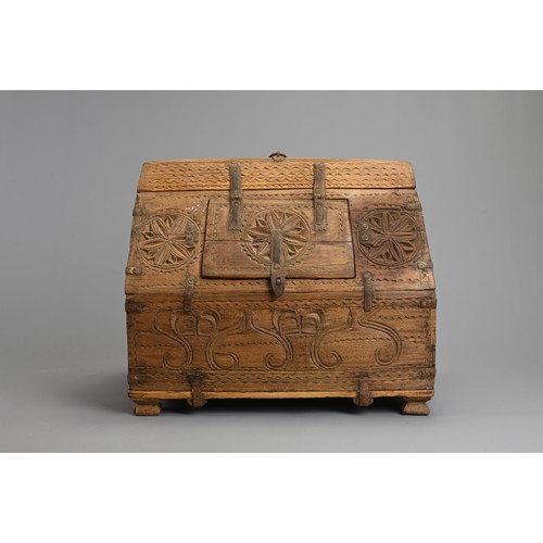 122 - AN INDIAN CARVED WOODEN DOWRY CHEST, 20TH CENTURY. With hinged panel to the roof of the box with iro... 