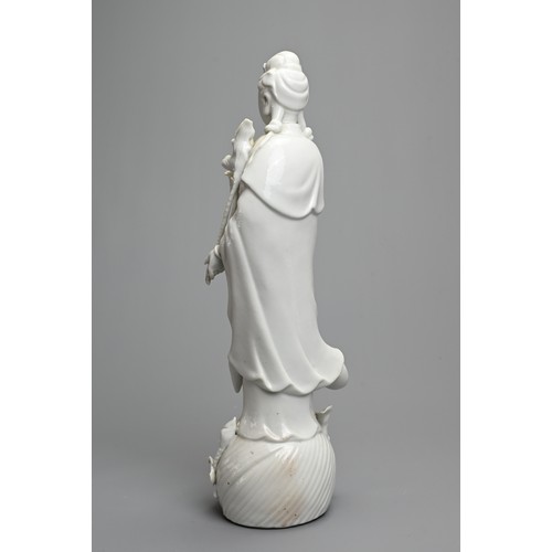 17 - A CHINESE BLANC DE CHINESE PORCELAIN FIGURE OF GUANYIN, 20TH CENTURY. Dressed in robes holding a lot... 