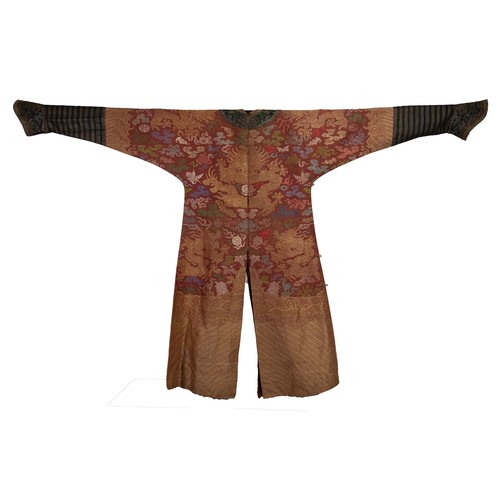 A CHINESE BROCADE SILK RED-GROUND DRAGON ROBE, LATE QING DYNASTY ...