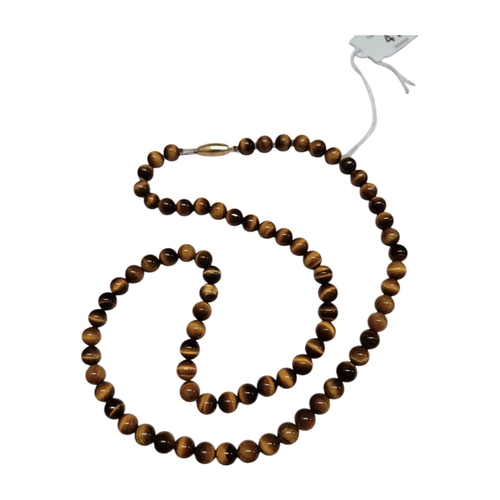 41 - TIGERS EYE NECKLACE WITH HEAVY 9CT GOLD CLASP APPROX 66CMS LONG