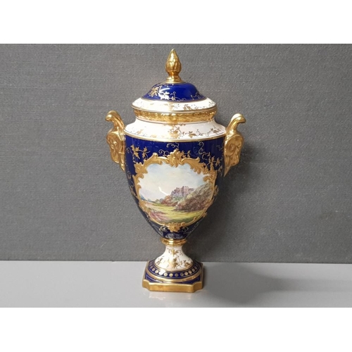 386 - BEAUTIFUL LIDDED HAND PAINTED COALPORT URN VASE WITH LAVISH GILDED TWIN HANDLES MODELLED AS RAMS HEA... 