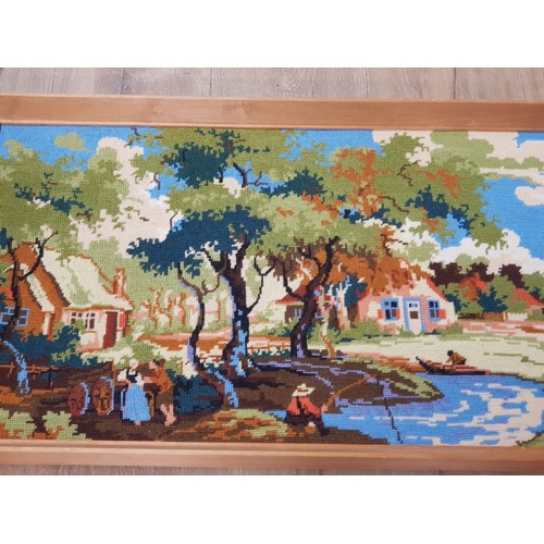 206 - A FRAMED TAPESTRY OF A VILLAGE SCENE WITH PEOPLE FISHING BASED AROUND THE 1800S