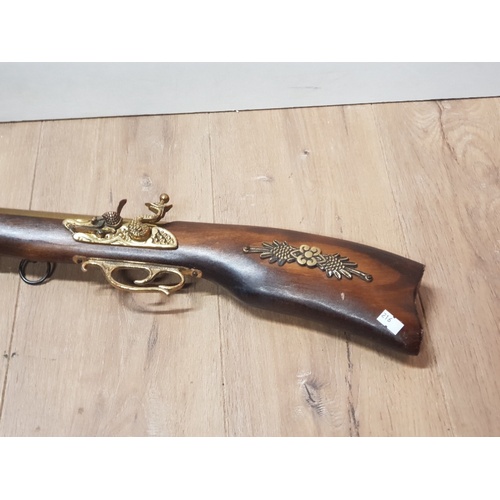 209 - A WOODEN BRASS ORNAMENTAL FLINT LOCK BLUNDERBUSS