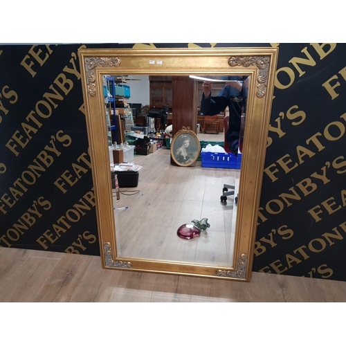 136 - A LARGE GILT FRAMED MIRROR WITH BEVEL EDGE 80CM BY 110CM