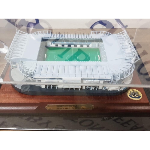 147 - NEWCASTLE UNITED ST JAMES PARK STADIUM REPLICA IN DISPLAY CASE WITH 12 PIN BADGES AND A COAT (SIZE 3... 