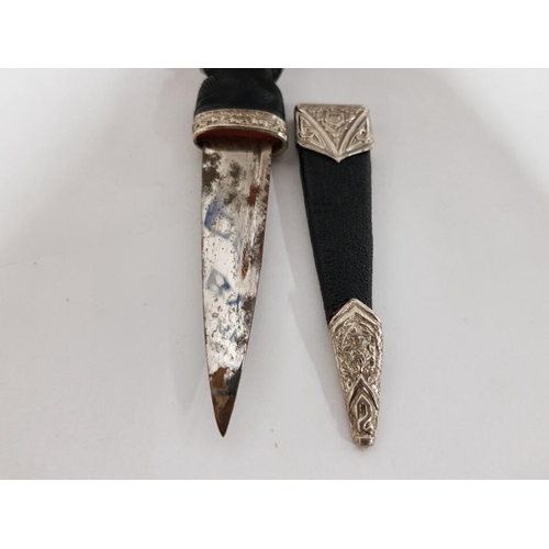 173 - A SGIAN-DUBH WITH STEEL MOUNTS (PASTE STONE MISSING TO GRIP)