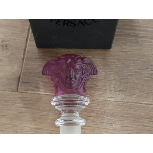 192 - VERSACE FOR ROSENTHAL AN AMETHYST COLOURED GLASS BOTTLE STOPPER IN ORIGINAL BOX