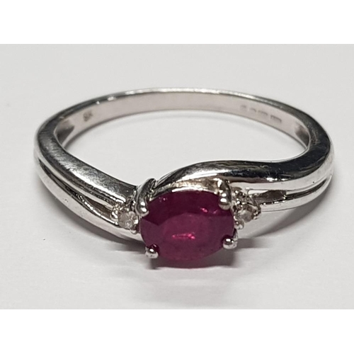 365 - 9CT WHITE GOLD OVAL RUBY STONE RING WITH TWO SMALL DIAMONDS, 2.5G GROSS SIZE N1/2