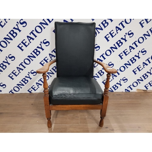 387 - A LEATHER AND BEECH OPEN ARMCHAIR