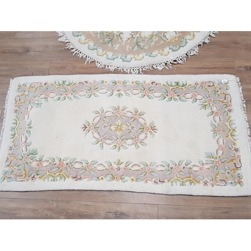 399 - CIRCULAR SHAPED FLORAL PATTERNED FRINGED RUG DIAMETER 124CM, TOGETHER WITH MATCHING RECTANGULAR SHAP... 