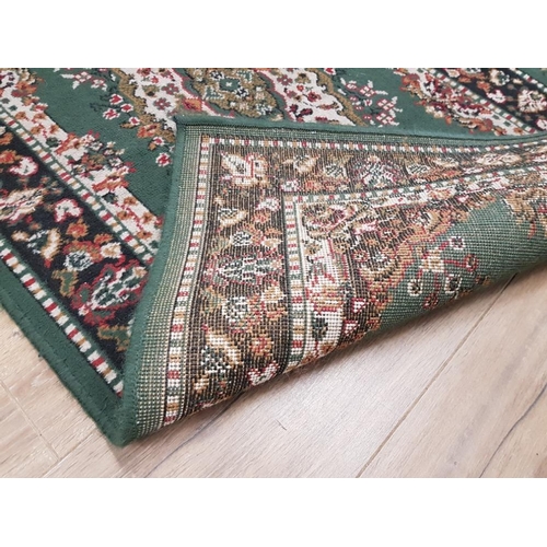 401 - A MODERN RUNNER ON BEIGE GROUND 273 X 102CM AND A GREEN PERSIAN STYLE RUG