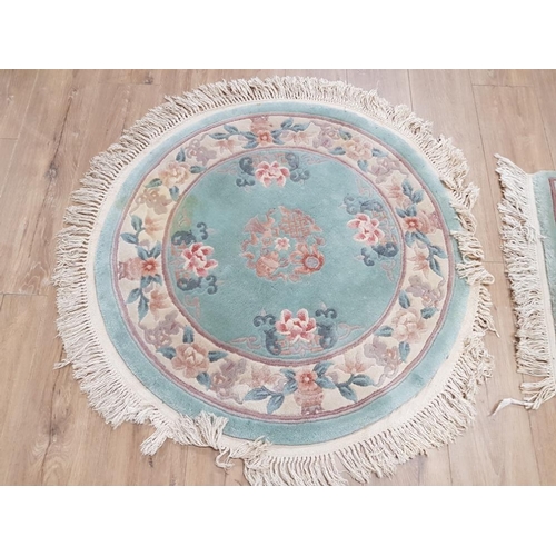 407 - TWO GREEN FLORAL PATTERNED CHINESE RUGS ONE CIRCULAR 100CM DIAMETER AND ONE RECTANGULAR 128 X 61CM