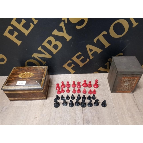 438 - A RED AND BLACK PAINTED METAL CHESS SET TOGETHER WITH TWO VINTAGE TINS