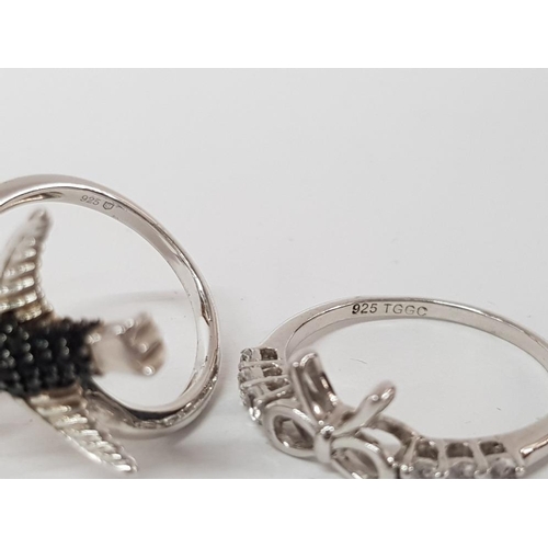 130 - TWO SILVER WHITE AND BLACK STONE RINGS IN THE FORM BIRDS AND A BOW STAMPED SIZES P 1/2 AND T 1/2 8G ... 