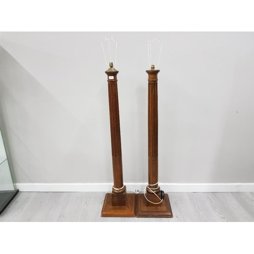 171 - A PAIR OF EARLY 20TH CENTURY OAK STANDARD LAMPS ON THE FORM OF COLUMNS 127CM