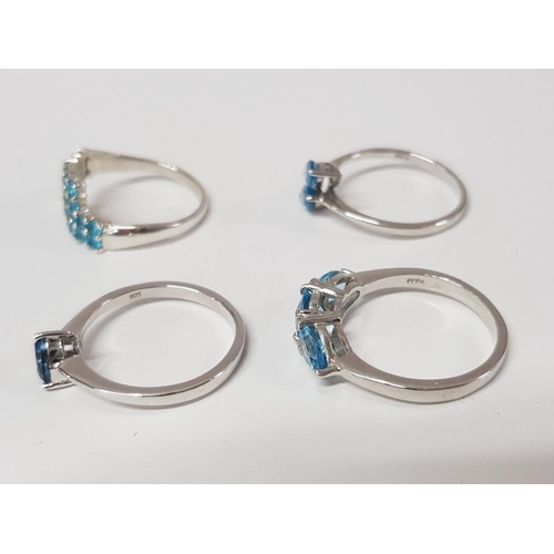 189 - FOUR SILVER AND BLUE STONE RINGS STAMPED SIZES R R 1/2 AND S 11G GROSS