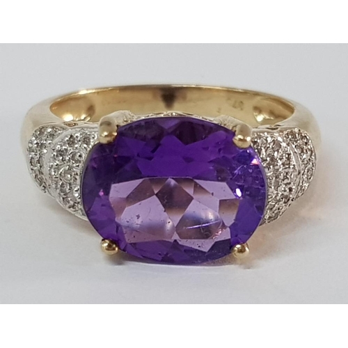 217 - 9CT YELLOW GOLD OVAL AMETHYST AND DIAMOND RING, 3.9G SIZE O