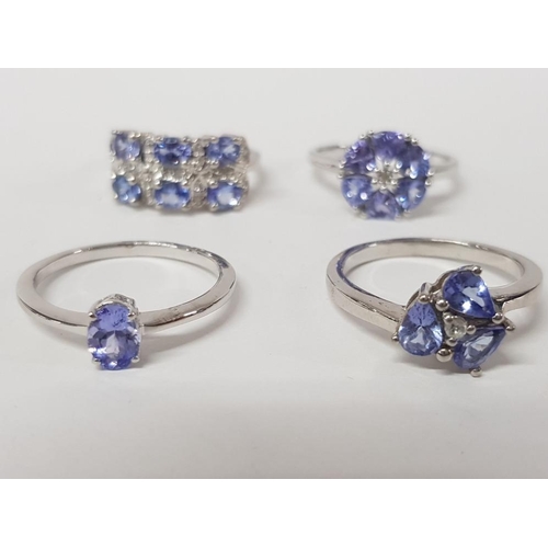 233 - FOUR SILVER AND BLUE STONE RINGS STAMPED SIZES R AND T 14.3G GROSS