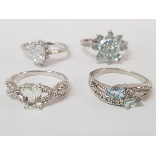 235 - FOUR SILVER AND PALE BLUE STONE RINGS STAMPED SIZES R R 1/2 AND T 1/2 13.9 G GROSS