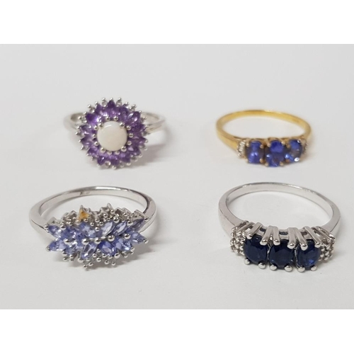 238 - FOUR SILVER BLUE STONE AND PURPLE RINGS STAMPED ONE GILT SIZES S T AND T 1/2 12.5G GROSS