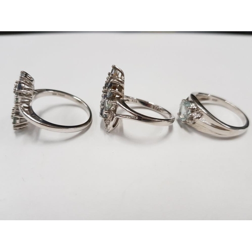 294 - THREE SILVER AND BLUE STONE RINGS STAMPED SIZES R 1/2 AND T 1/2