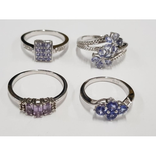 295 - FOUR SILVER AND PURPLE STONE RINGS STAMPED SIZES N 1/2 R 1/2 S AND U