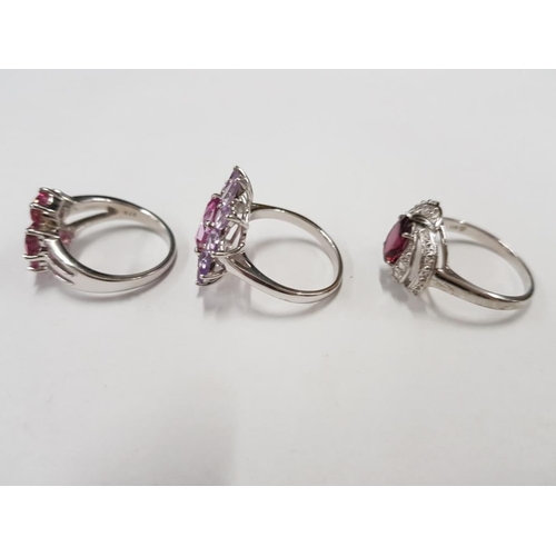 297 - THREE SILVER AND PINK STONE RINGS STAMPED SIZES R 1/2 AND U 14.9G GROSS